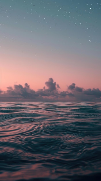 Calm ocean surface at dusk with a sky full of stars