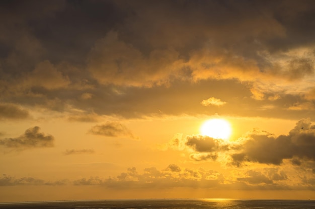 Calm sea with sunset sky and sun through the clouds over Calm sea with sunset sky and sun through the clouds over Meditation ocean and sky background Tranquil seascape Horizon over the water