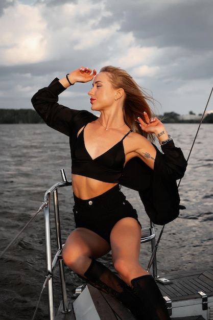 Calm stylish lady admiring sea during cruise on boat