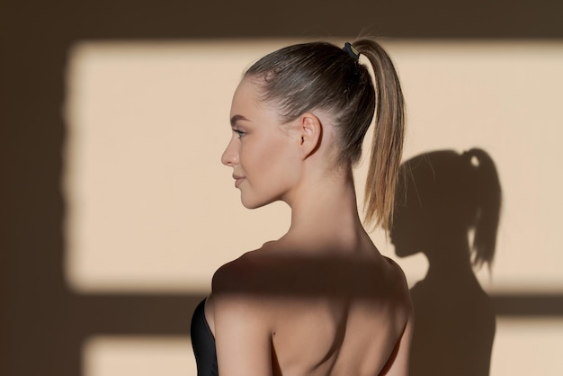 Calm thoughtful Young beautiful slim caucasian woman in black swimsuit