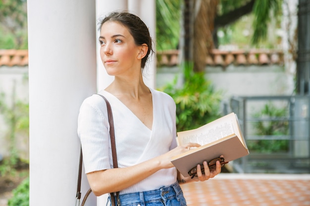 Calm woman thinking about a book she is reading