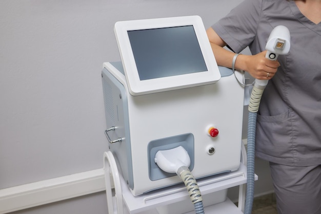 Calm young woman lying with closed eyes and putting on arm up while having laser hair removal proced