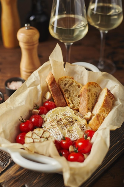 Camembert cheese baked with cherry tomatoes and baguette