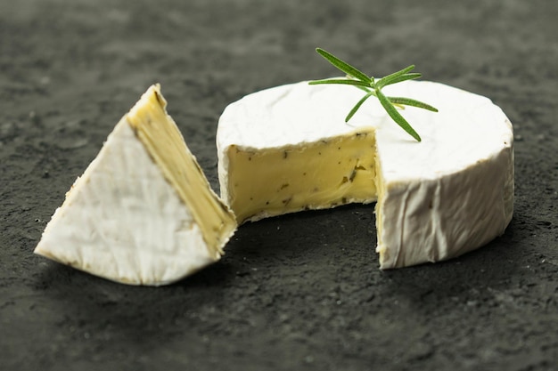 Camembert cheese on a black background.