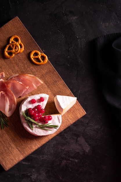 Camembert cheese decorated with berries and rosemary