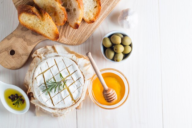 Camembert cheese with toast bread on wooden background.