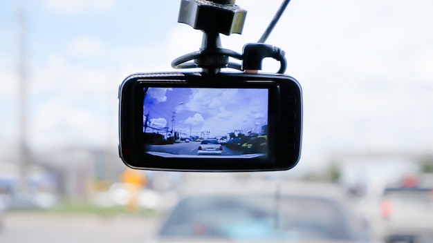 Camera on the front of a car  Background Cars on the road and clouds in the sky.