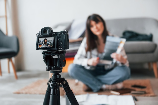 Camera is on the floor Young female freelance worker is indoors in home at daytime