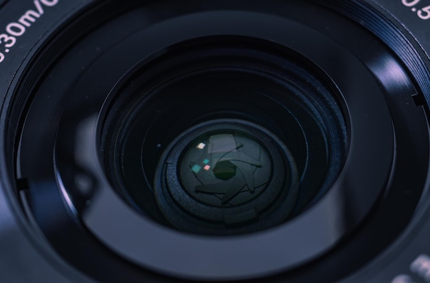 A camera lens with a green dot on the bottom