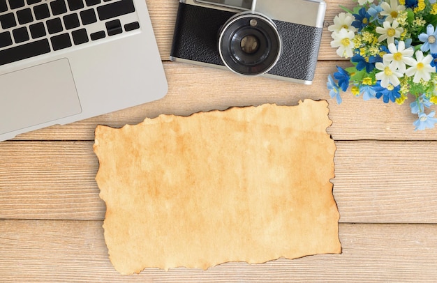 Camera and supplies on office wooden desk table