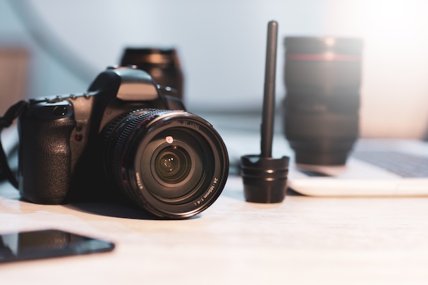 Camera with lens and brush on table