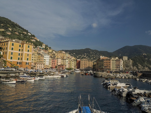 Camogli typical village with colorful houses and small harbor in Italy, Liguria in a sunny day view from the boat