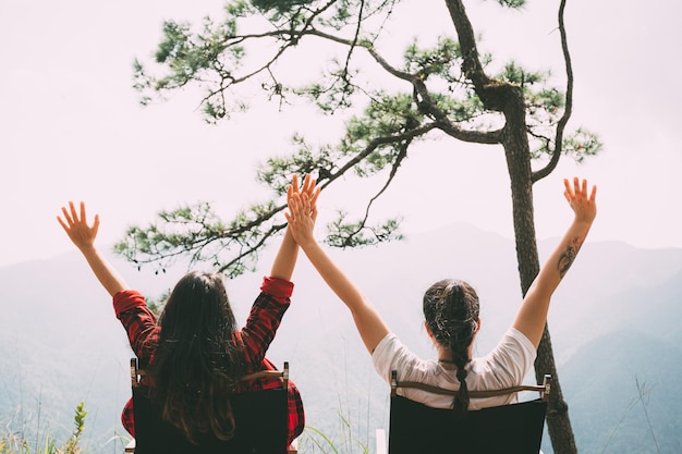 Camp women raise their hands to admire the air