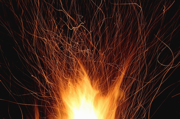 Campfire fire flames with sparks on a dark background