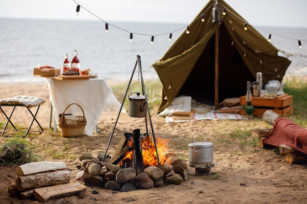 Campground with a campfire on the lake shore.