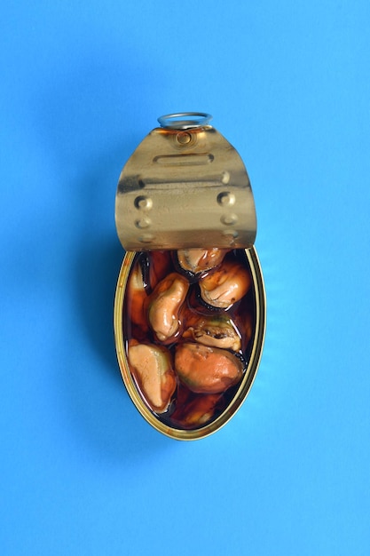 Can of pickled mussel on blue background