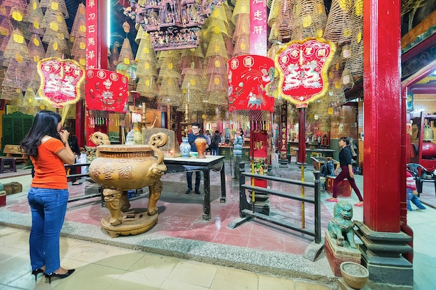 Can Tho, Vietnam - February 27, 2016: Woman praying in Ong Temple in Can Tho, in Vietnam