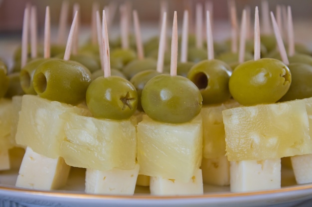 Canapes of pineapple, cheese and olives