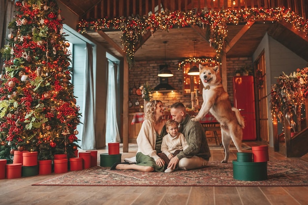 Candid authentic happy family during wintertime together enjoying holidays with dog at Xmas