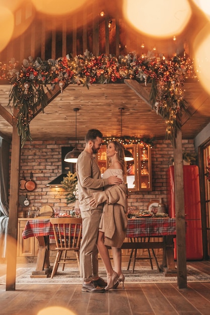 Candid authentic happy married couple spending time together at wooden lodge Xmas decorated