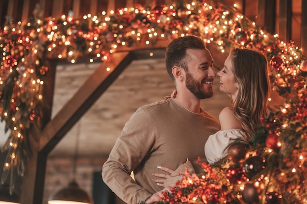 Candid authentic happy married couple spending time together at wooden lodge Xmas decorated