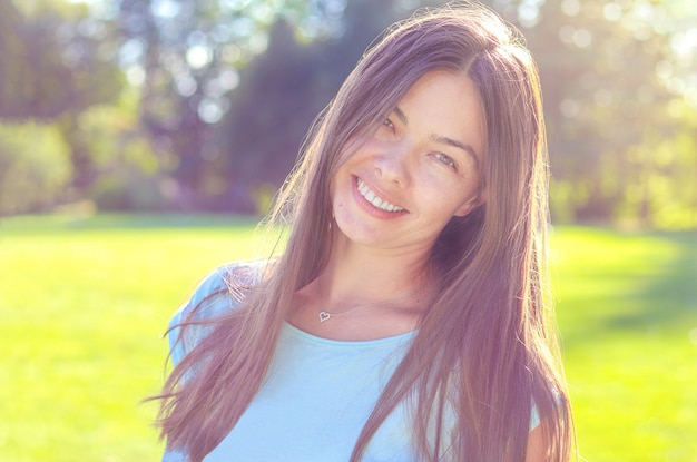 Candid portrait of happy smiling beautiful woman outdoors, natural girl beauty without makeup. 