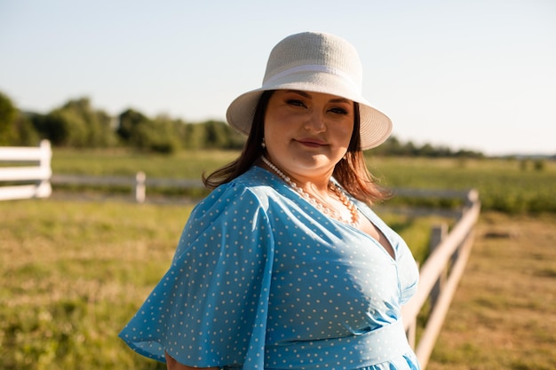 Candid woman in hat at farmland enjoy the summer