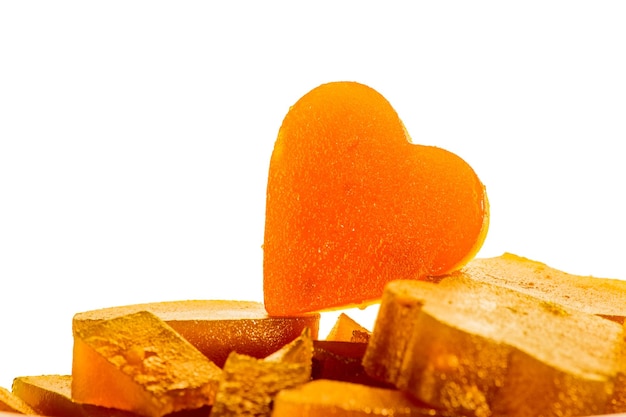 Candied fruit jelly apricot in the form of heart on isolated background