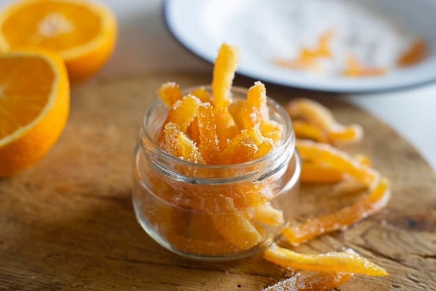 Candied orange sticks in sugar served in a glass.