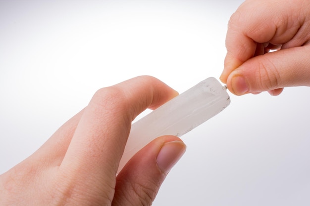 Candle stick in hand on a white background