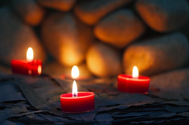 Candles are lit on the background of the sauna stones. Preparing for the ceremony bathhouse