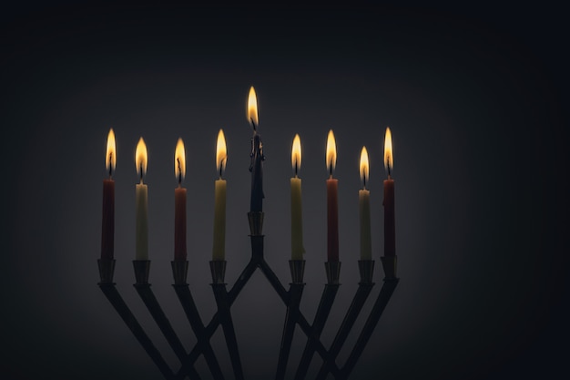 Candles lit for night of hanukkah with burning candles for holiday