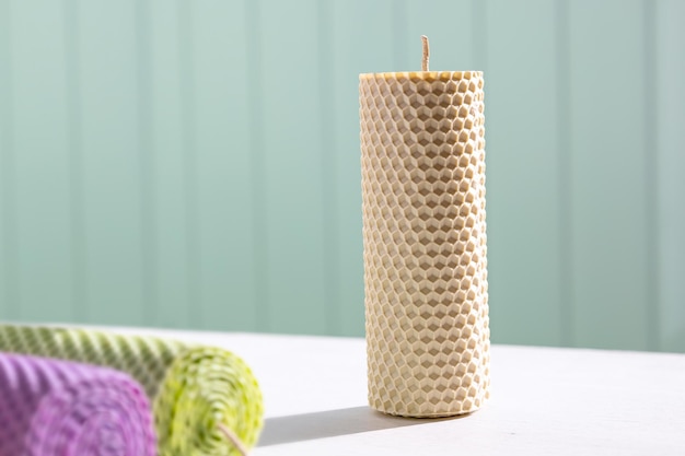 Candles made of beeswax on white table in sunny day