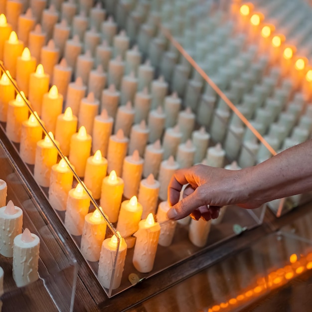 Candles that are lit with alms inside Catholic churches in Spain