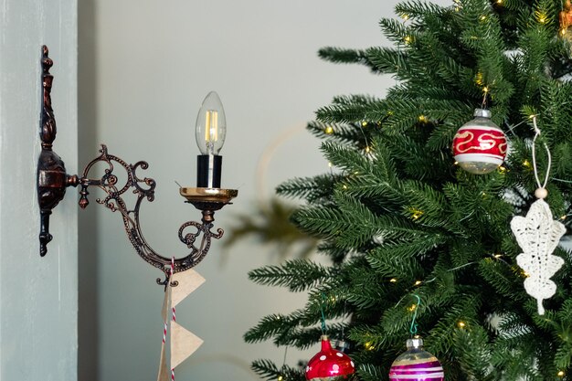 Candlestyle lamp in a candelabra near the Christmas tree