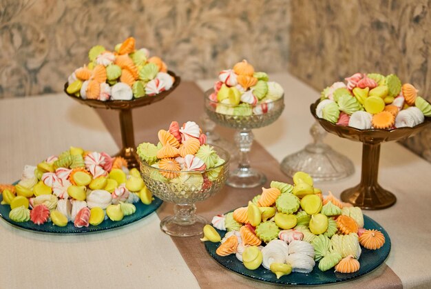 Candy bar decorated by delicious sweet buffet with cupcakes and other dessertscandieshappy birthday concept