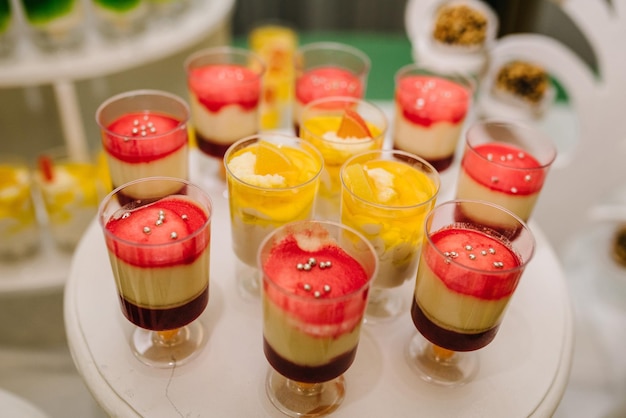 Candy bar Delicious wedding reception on dessert table Festive table with sweets candies desserts tartlet and cupcakes Side view Close up