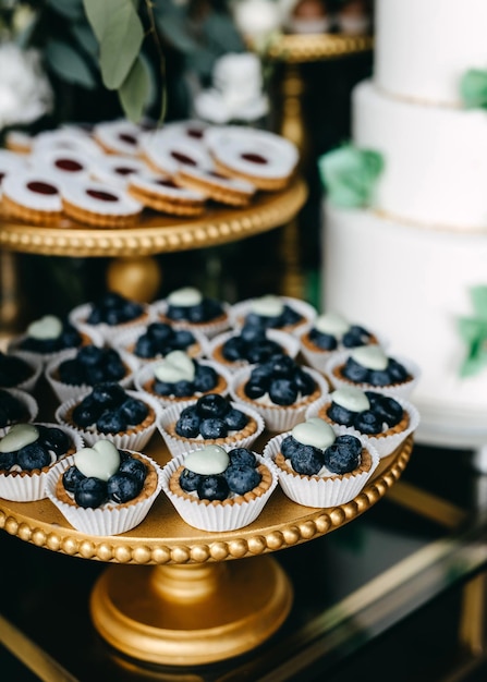 Candy bar at a party Sweet table with blueberry cupcakes and different handmade desserts