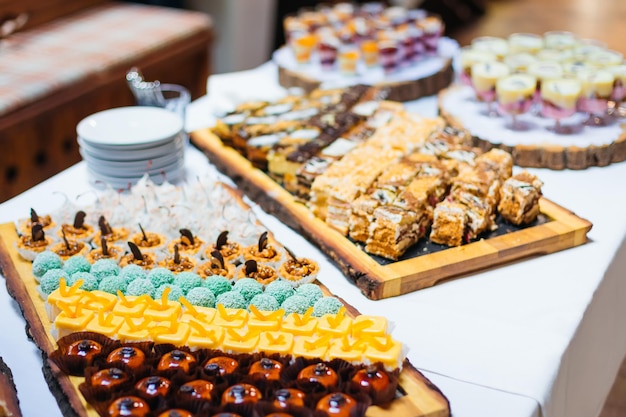 Candy bar served with glassware table with sweets for weddings engagements birthdays