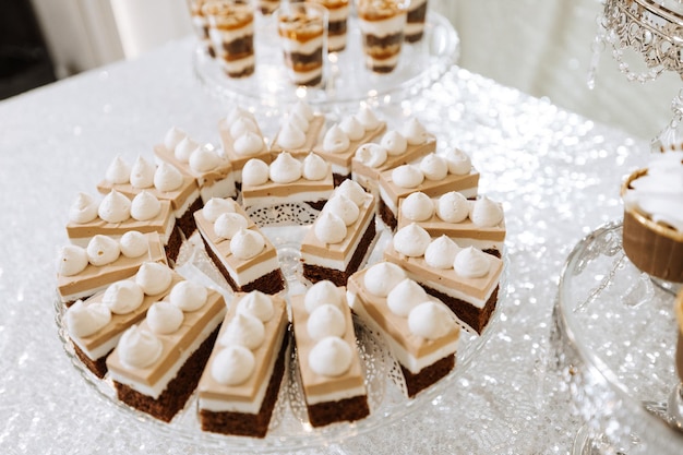 Candy bar for a wedding Candy bar standing festive table with desserts cupcakes and macarons Beautiful and tasty