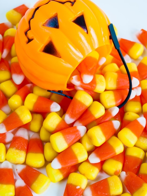 Photo candy corn candies falling out of halloween treat bag.