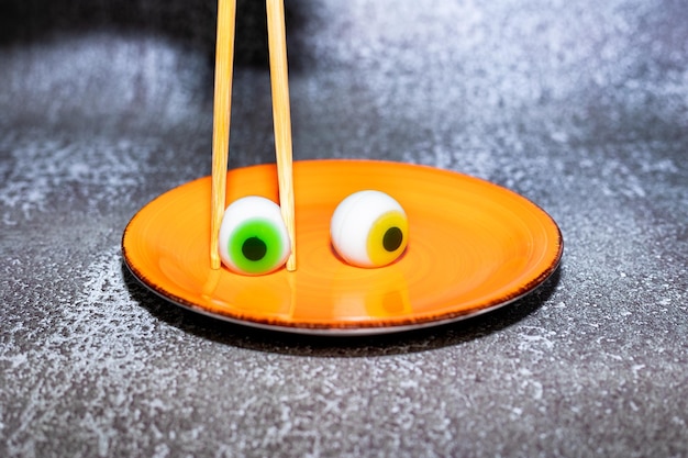 Candy eyes on orange plate