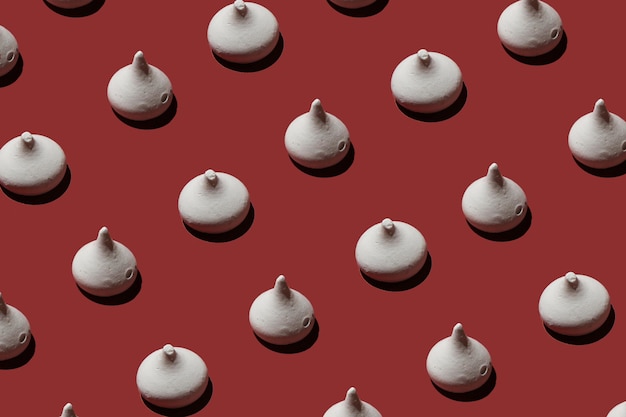 Candy in the form of nipples pattern on a red background