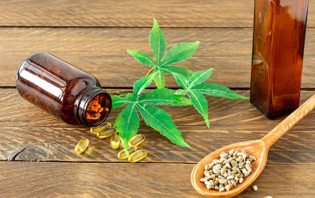 Cannabis CBD oil hemp products - capsules and seeds of hemp.