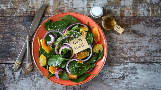 Cannabis oil salad. Healthy salad with spinach and orange.