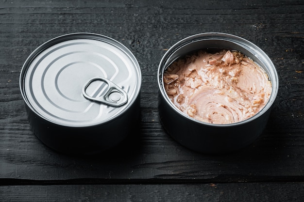 Canned Albacore Wild Tuna set, in tin can, on black wooden table