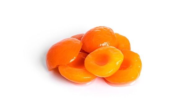 Canned apricots isolated. Sweet apricots in syrup isolated on white.