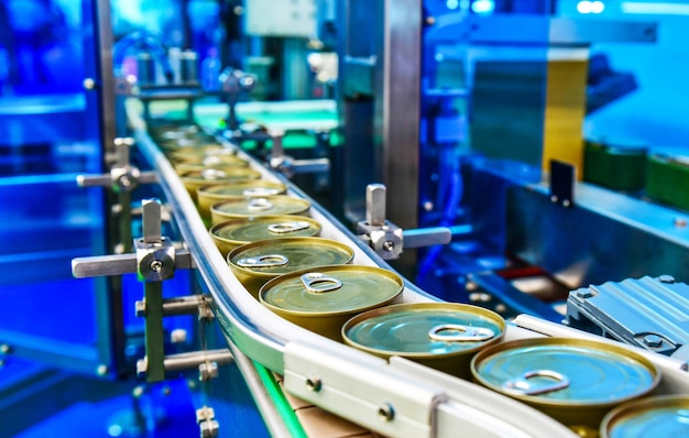 Canned food products on conveyor belt in distribution warehouse