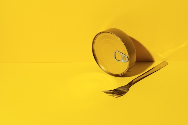 Canned food tin on yellow studio background