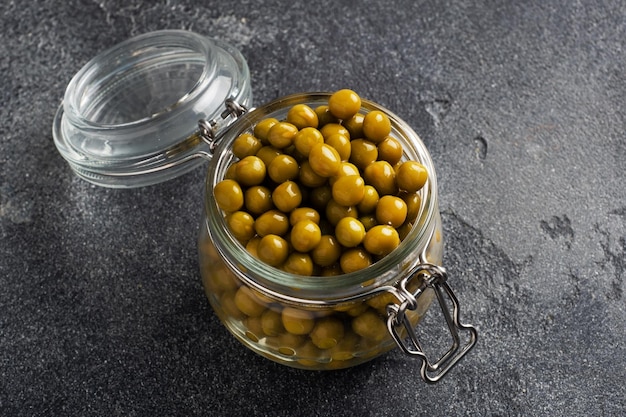 Canned green peas in a glass jar Homemade fermented food copy space